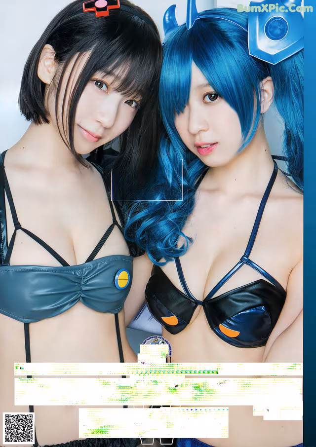 A couple of young women in lingersuits posing for a picture.