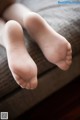 A close up of a baby's feet on a couch.