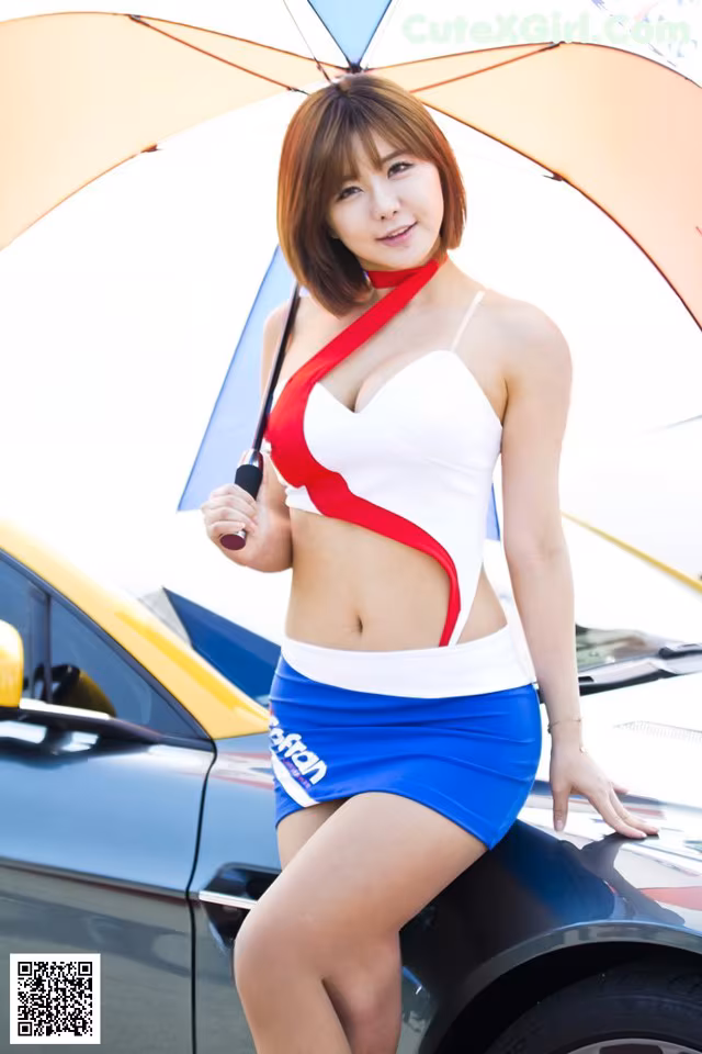 A woman in a bikini holding an umbrella next to a car.
