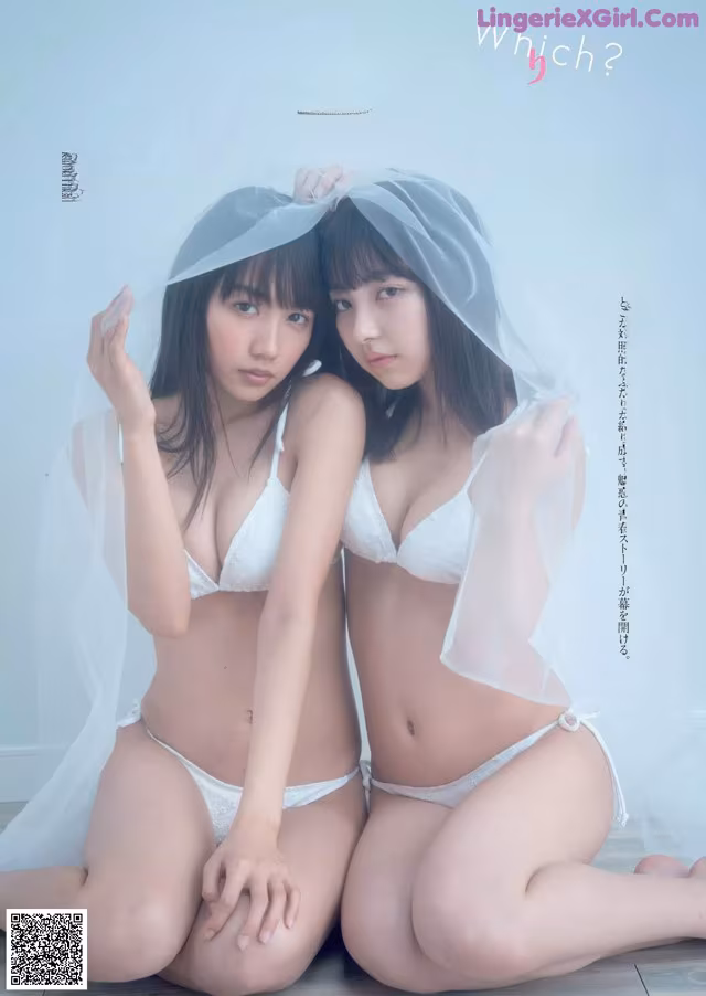 A couple of women in lingersuits sitting on the floor.