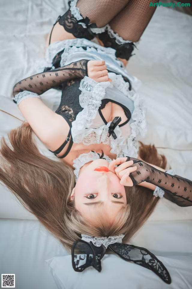 A woman laying on top of a bed in lingerie.