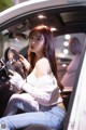 A woman sitting in the driver's seat of a car.