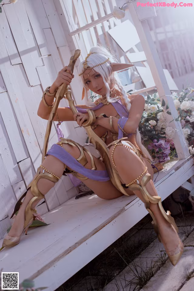 A woman sitting on a bench holding a sword.