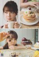 A woman sitting at a table with a plate of pancakes and a cup of coffee.