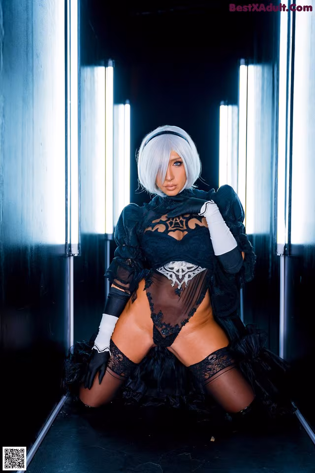 A woman in a black dress and white gloves posing for a picture.