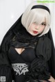 A woman in a black and white outfit is posing for a picture.
